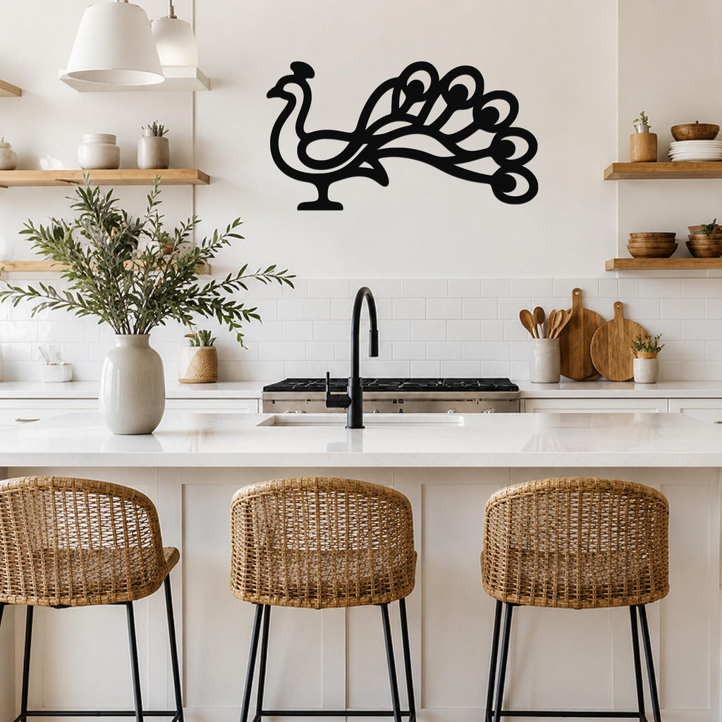 Black metal peacock wall art with a graceful silhouette and detailed tail cutouts, mounted on a kitchen wall above a counter.