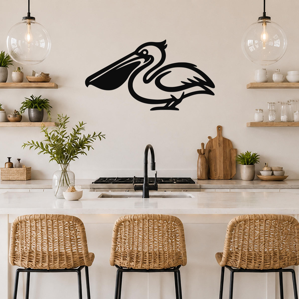 Black metal pelican wall art silhouette mounted above a kitchen counter, featuring a stylized bird with a long beak and curved neck, displayed in a modern coastal kitchen with open shelving and pendant lights.
