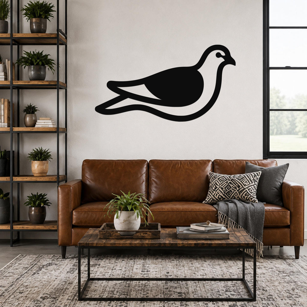 Black metal pigeon wall art silhouette with internal cutout details, mounted above a brown leather sofa in a living room.