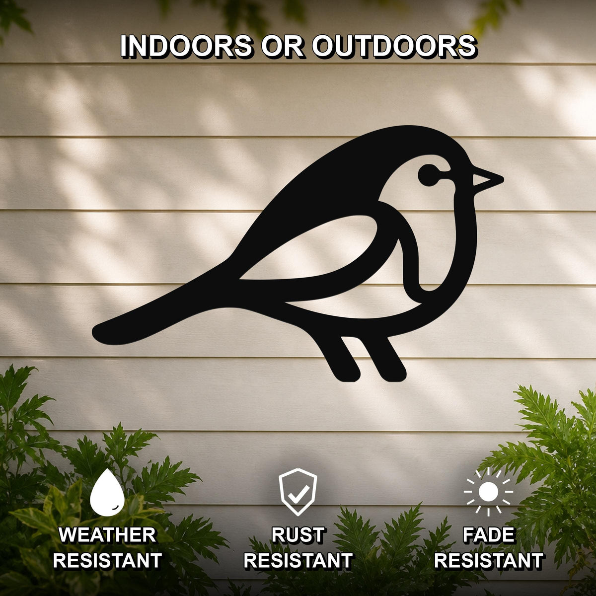 Black metal robin wall art silhouette mounted on a light-colored outdoor wall, weather resistant, rust resistant, and fade resistant, with green foliage visible at the bottom.