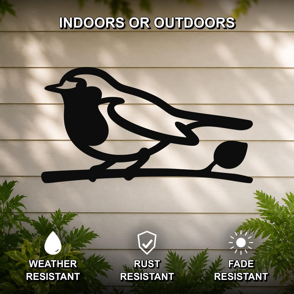 Black metal robin wall art silhouette perched on a branch, mounted on a light-colored outdoor wall with greenery, weather resistant, rust resistant, and fade resistant.