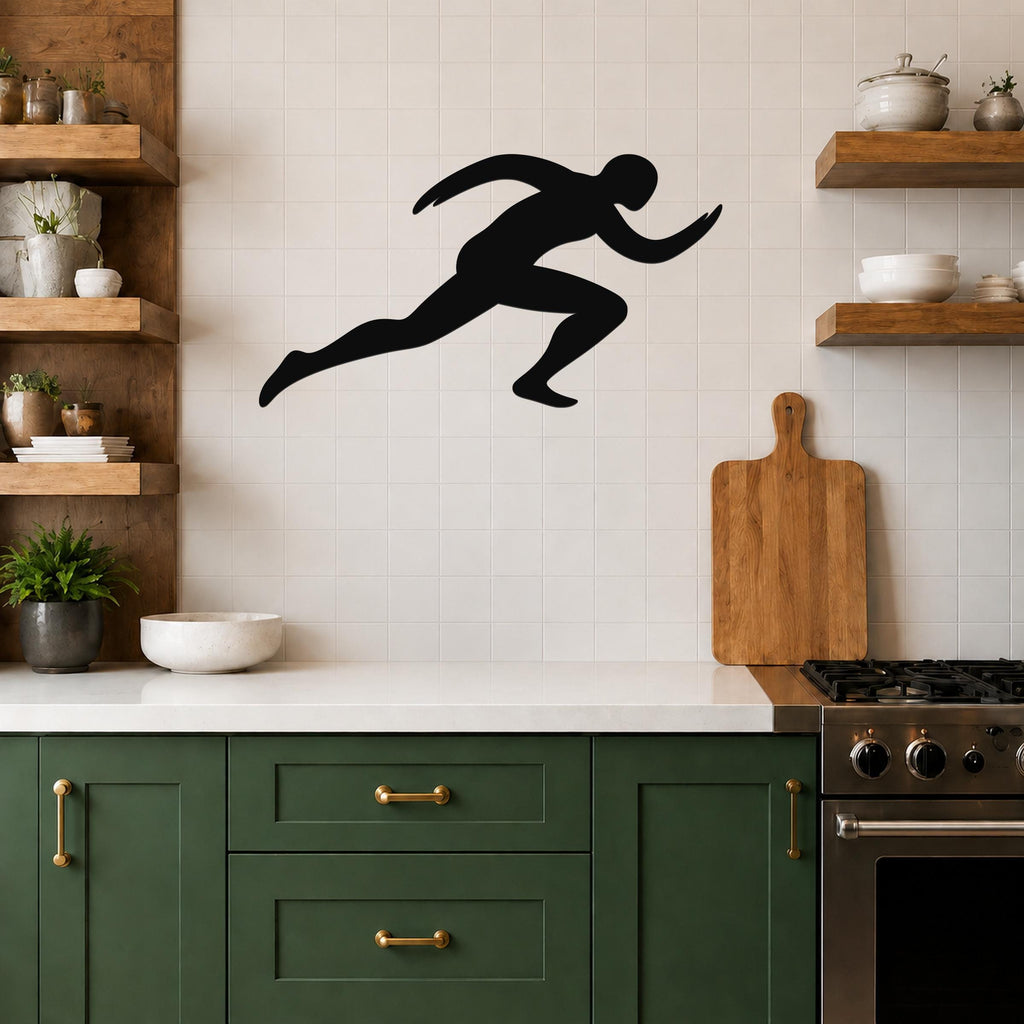 Black metal runner wall art with motion-line cutouts, mounted on a tiled kitchen wall above a counter.