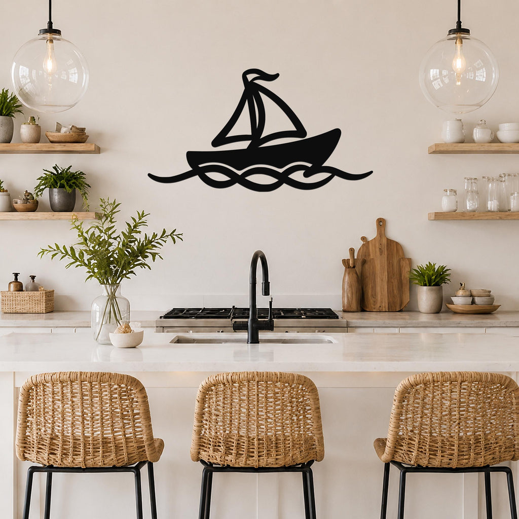 Black metal sailboat wall art with wave cutouts, mounted on a kitchen wall above a counter.