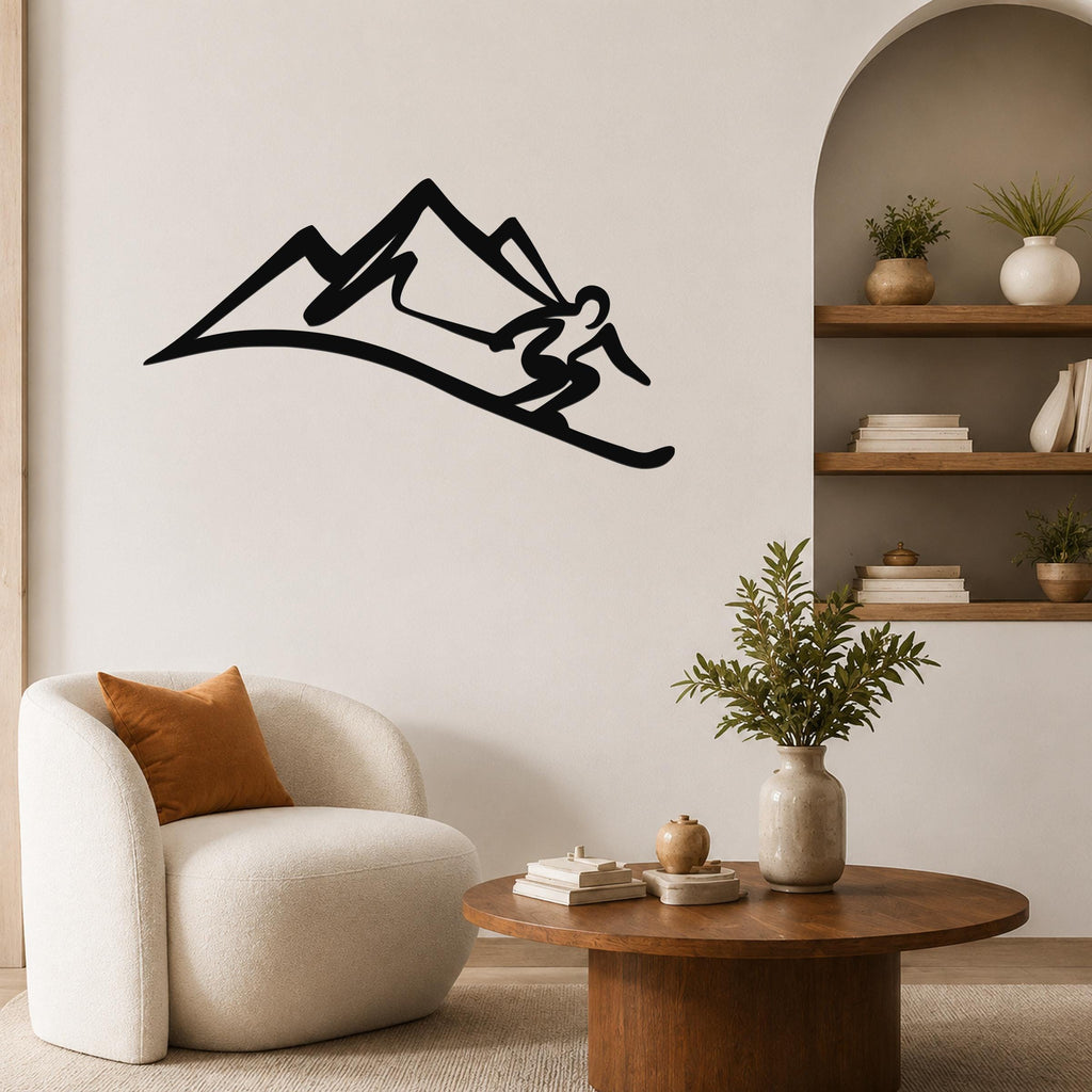 Black metal wall art silhouette of a skier in motion on a mountain slope, mounted on a living room wall above a round wooden coffee table.