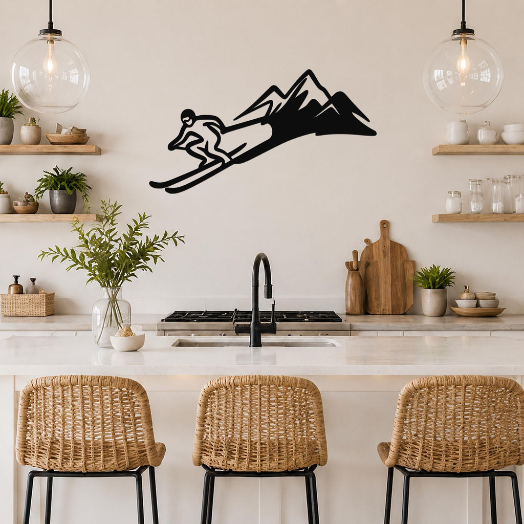 Black metal skier and mountain wall art silhouette mounted above a kitchen counter, featuring a dynamic cutout design of a skier in motion against a stylized mountain range.