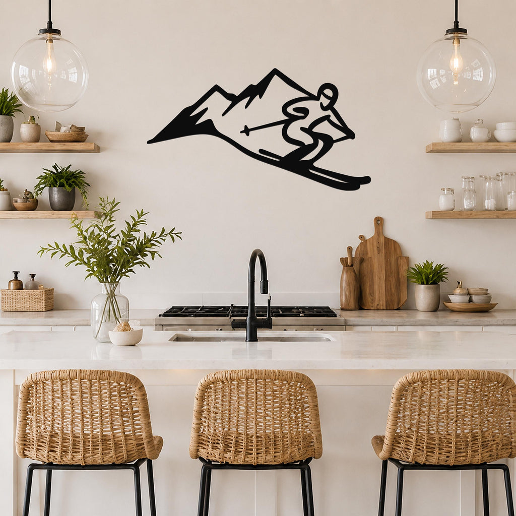 Black metal wall art cutout of a skier descending a mountain, mounted above a kitchen counter with wicker bar stools.