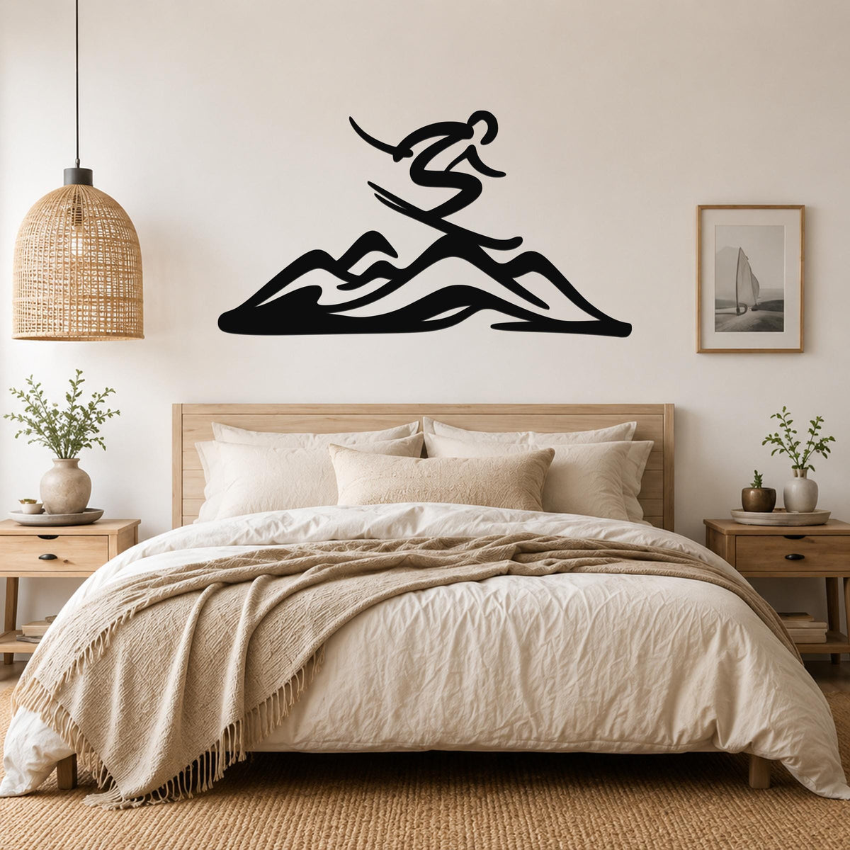 Black metal wall art featuring a skier silhouette above mountain peaks, mounted above a bed in a neutral bedroom.