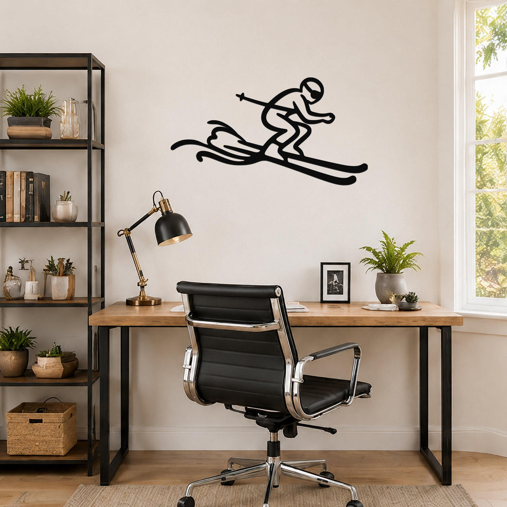 Black metal skier wall art with motion-line cutouts, mounted above a wooden desk in a home office.