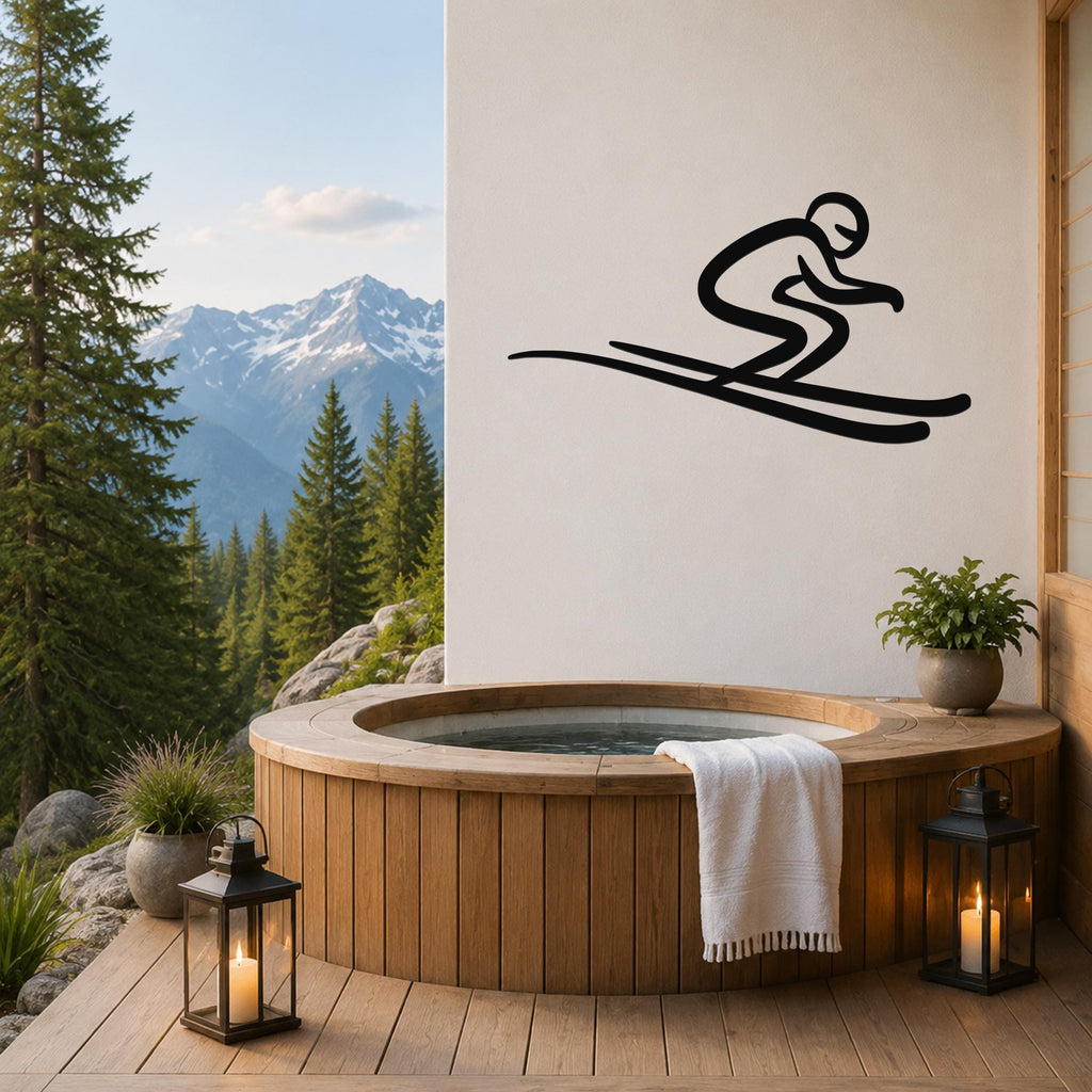 Black metal skier wall art with motion-line cutouts, mounted on a white wall above a wooden hot tub on a mountain-view deck.