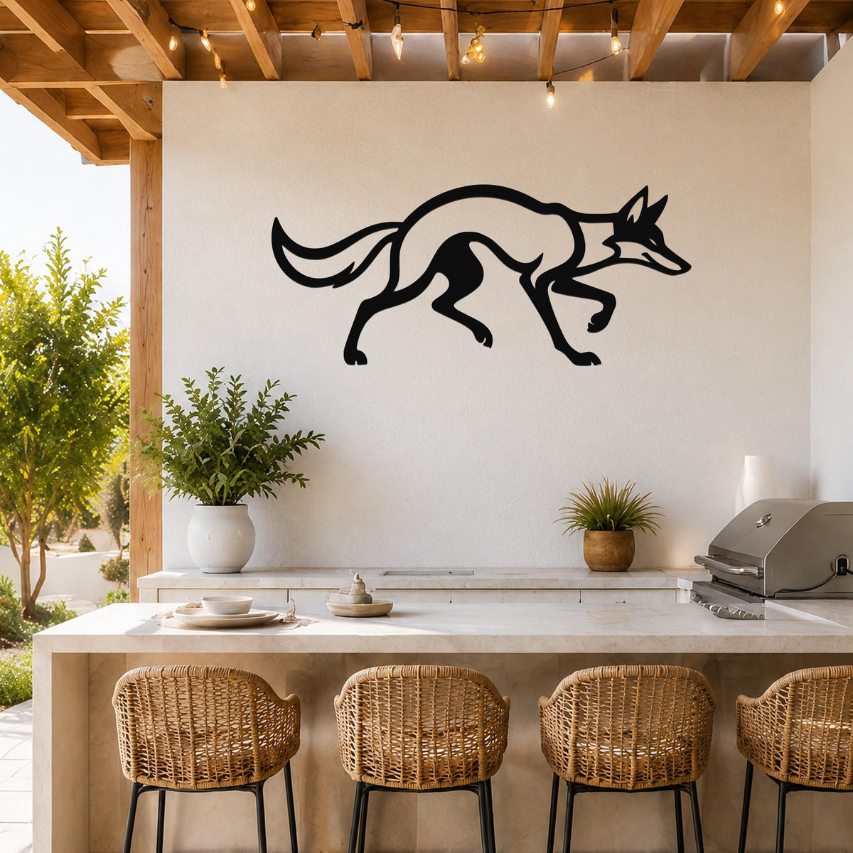 Black metal coyote wall art with a sleek silhouette design, mounted on a white wall above a kitchen counter with wicker bar stools.