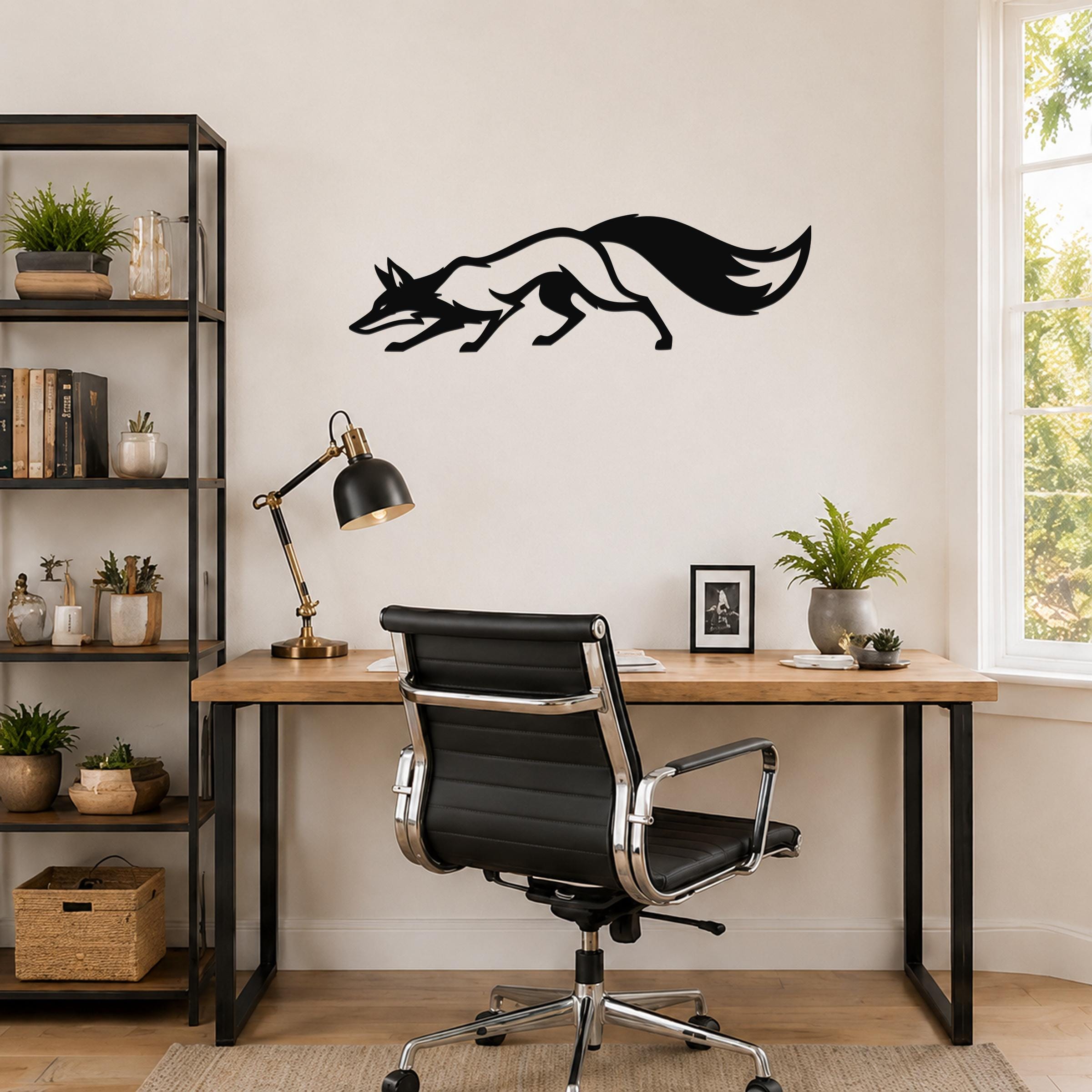 Black metal fox wall art silhouette with motion-line cutouts, mounted above a wooden desk in a home office.