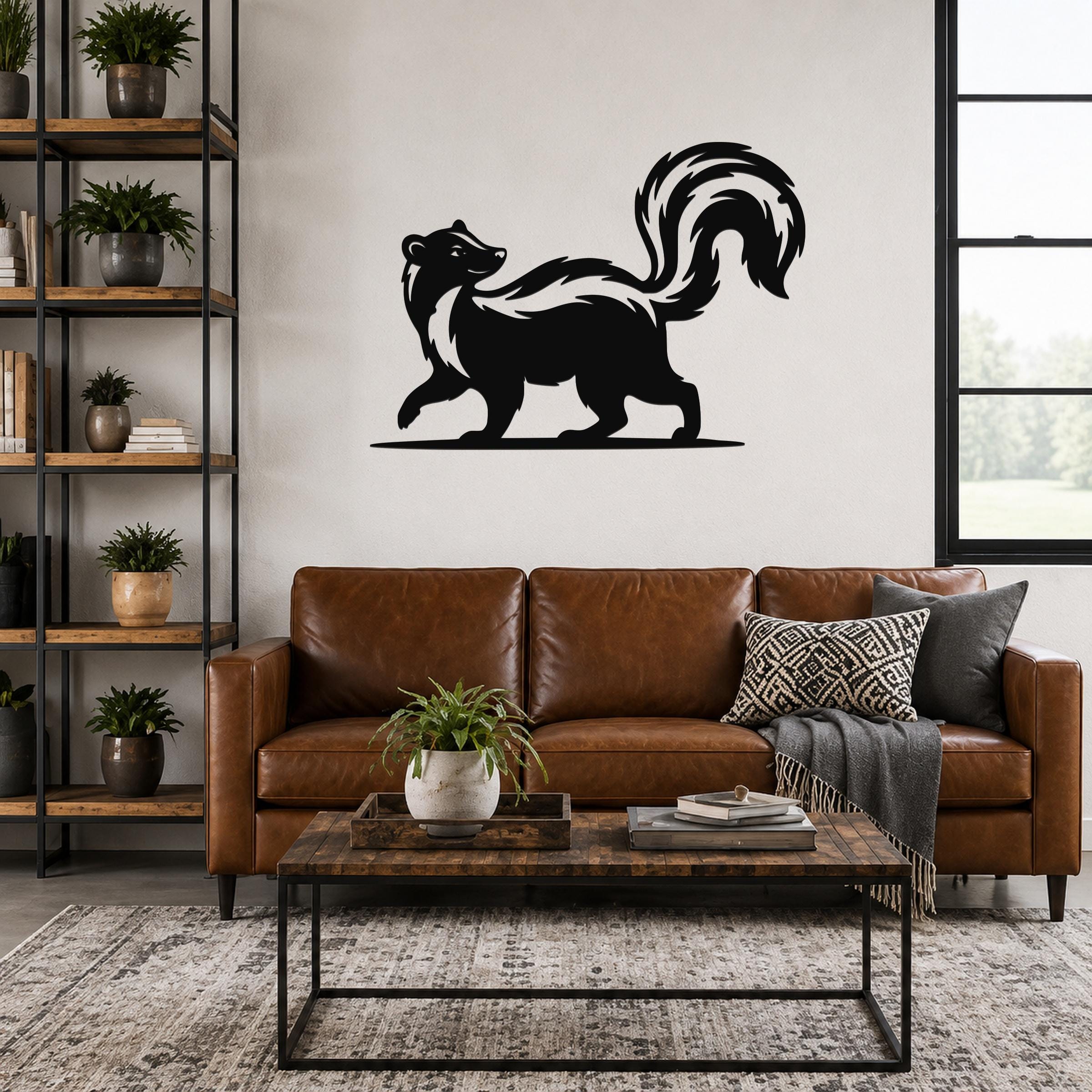 Black metal skunk wall art silhouette with a raised tail, mounted above a brown leather sofa in a living room.