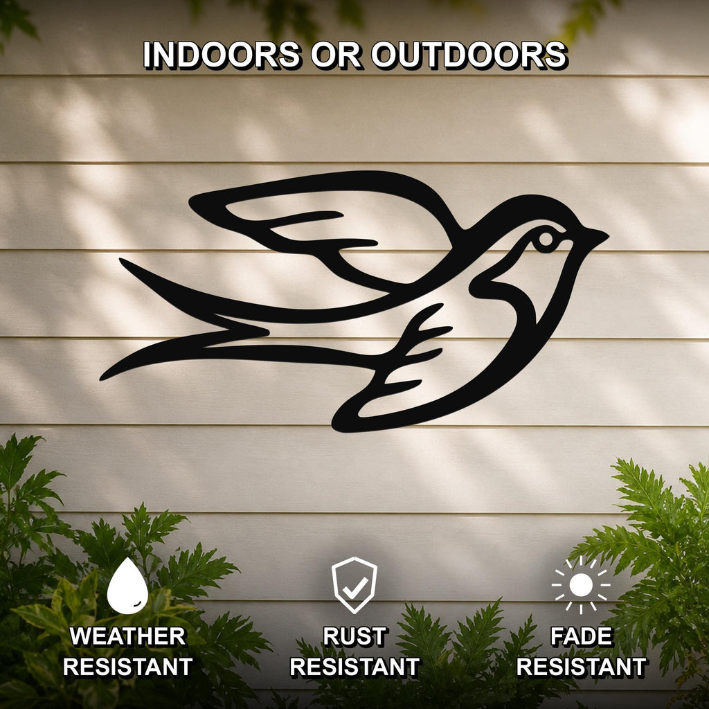 Black metal swallow bird wall art with motion-line cutouts, mounted on a light-colored outdoor wall with greenery below.