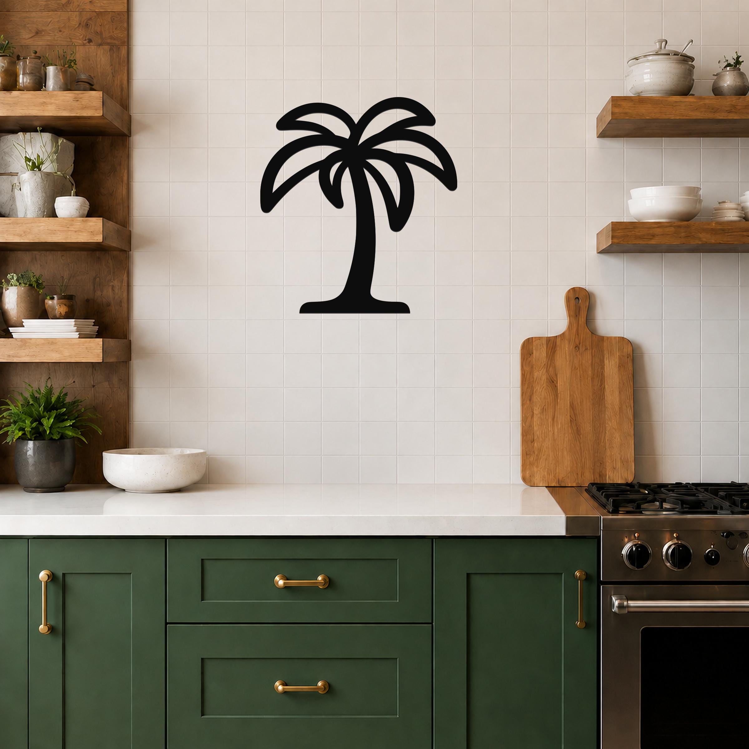 Black metal palm tree wall art with a silhouette design, mounted on a tiled kitchen wall above a counter.