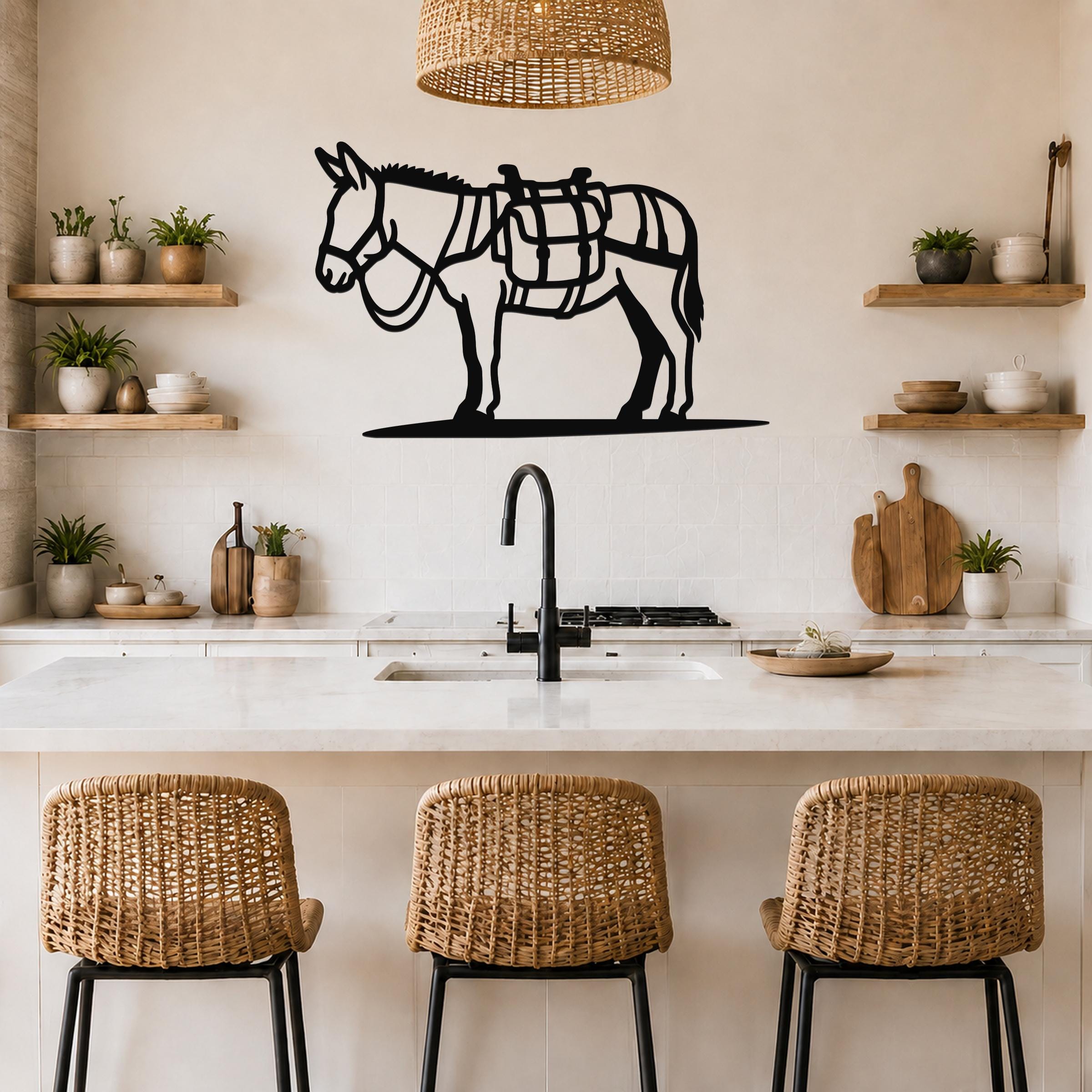 Black metal burro wall art with saddle cutout, mounted above a kitchen counter in a rustic modern kitchen.
