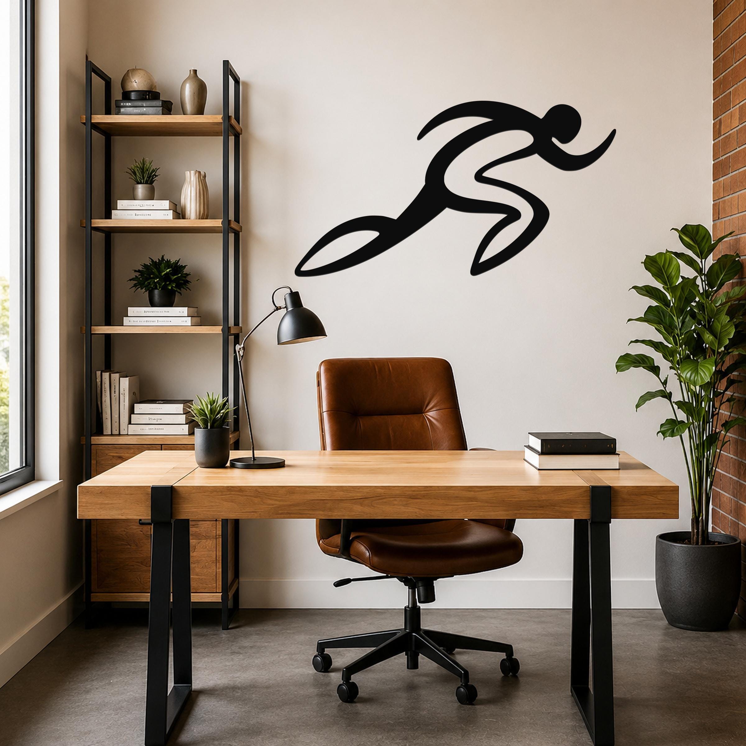 Black metal runner wall art with motion-line cutouts, mounted above a wooden desk in a modern home office.