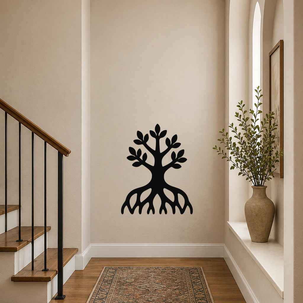 Black metal wall art in a tree silhouette with visible roots and leafy branches, mounted on a hallway wall near a staircase and a window with a potted plant.