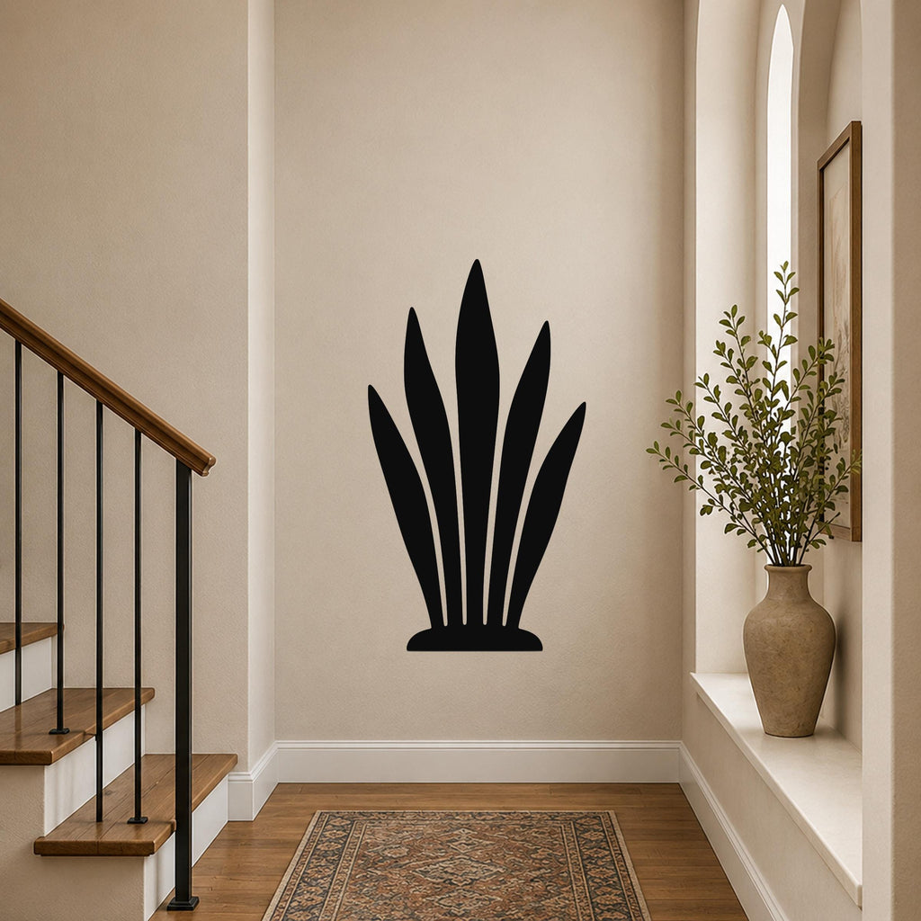 Black metal snake plant wall art with leaf cutouts, mounted on a hallway wall above a patterned rug.