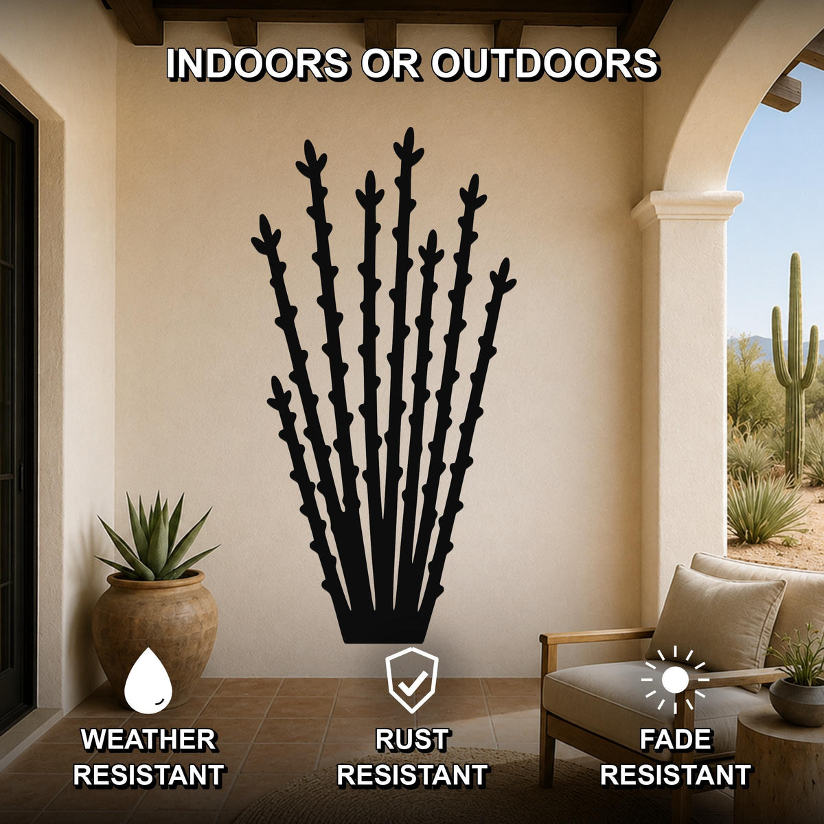 Black metal ocotillo wall art silhouette with spiny branches, mounted on a beige outdoor patio wall above a chair and potted plant.
