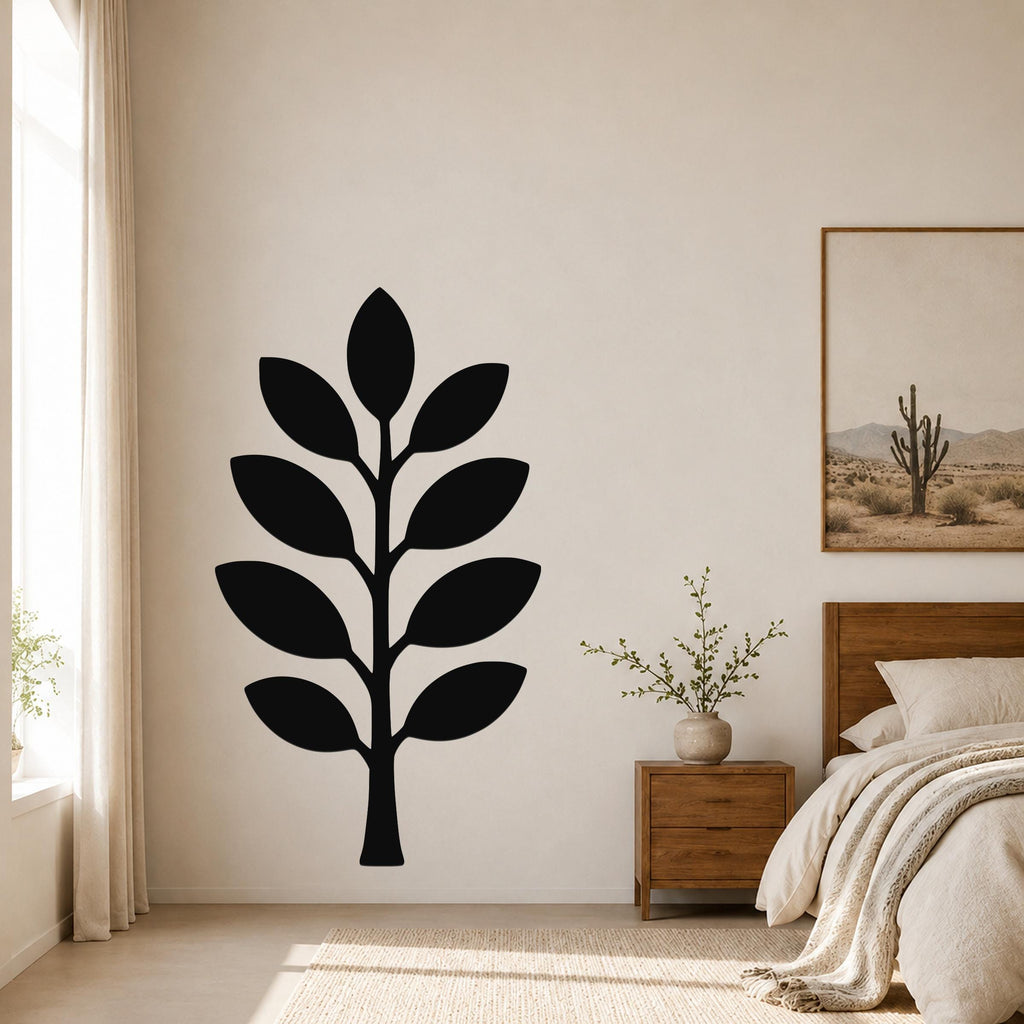 Black metal olive branch wall art with leaf cutouts, mounted on a bedroom wall above a nightstand.