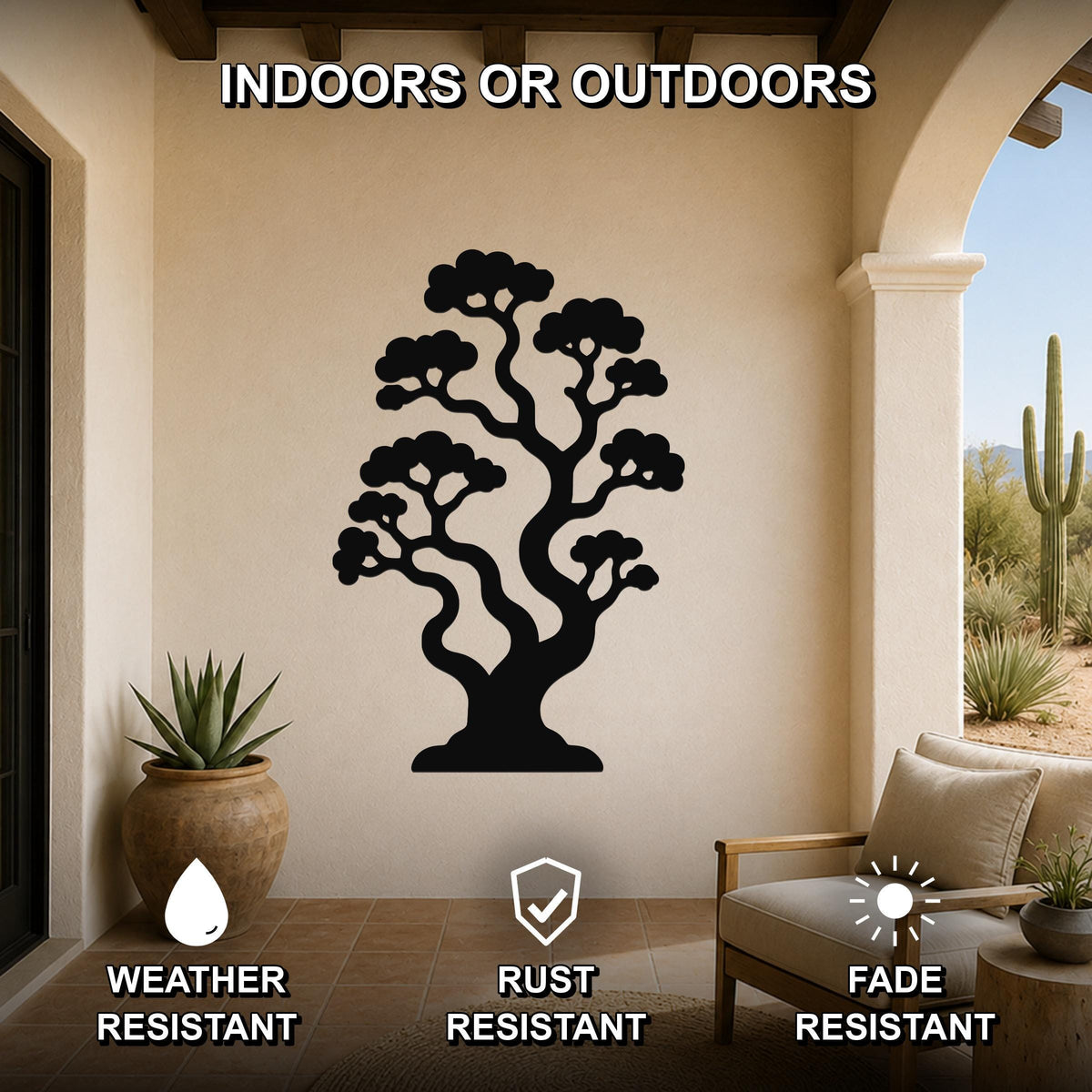 Black metal bonsai tree wall art with intricate branch cutouts, mounted on a beige patio wall above a wooden chair and potted plant.