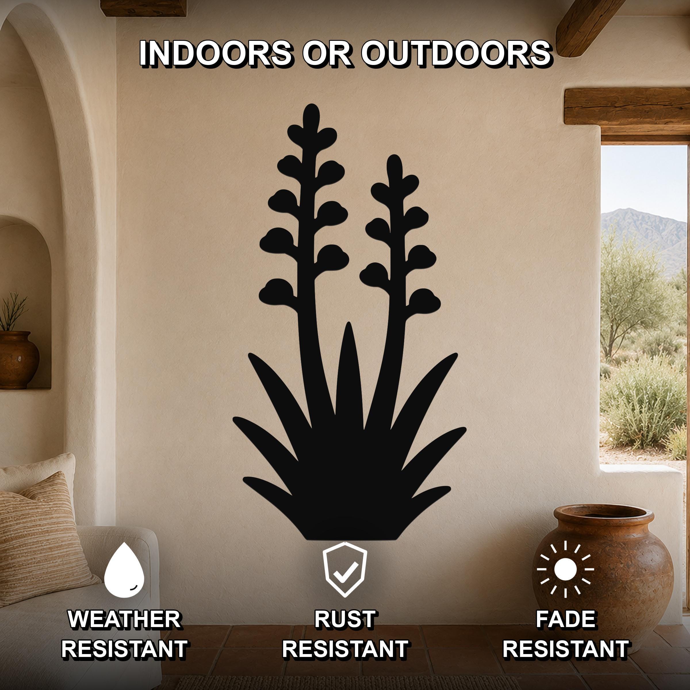 Black metal agave wall art with blooming flower cutouts, mounted on a beige living room wall above a sofa.