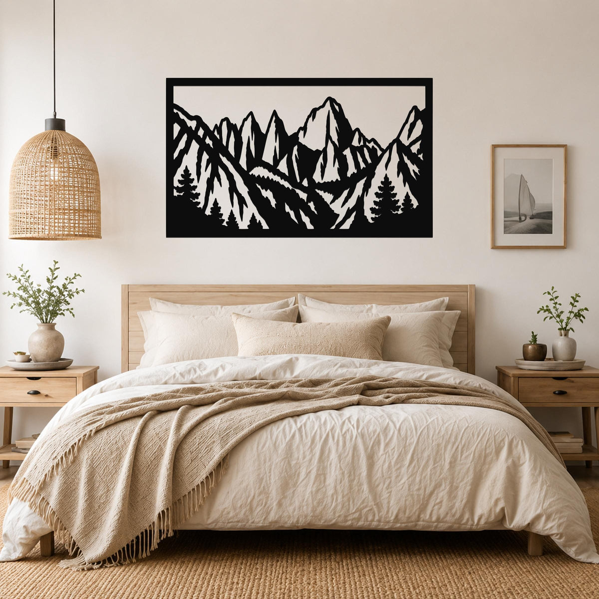 Black metal wall art with a mountain range silhouette, mounted above a bed in a bedroom.