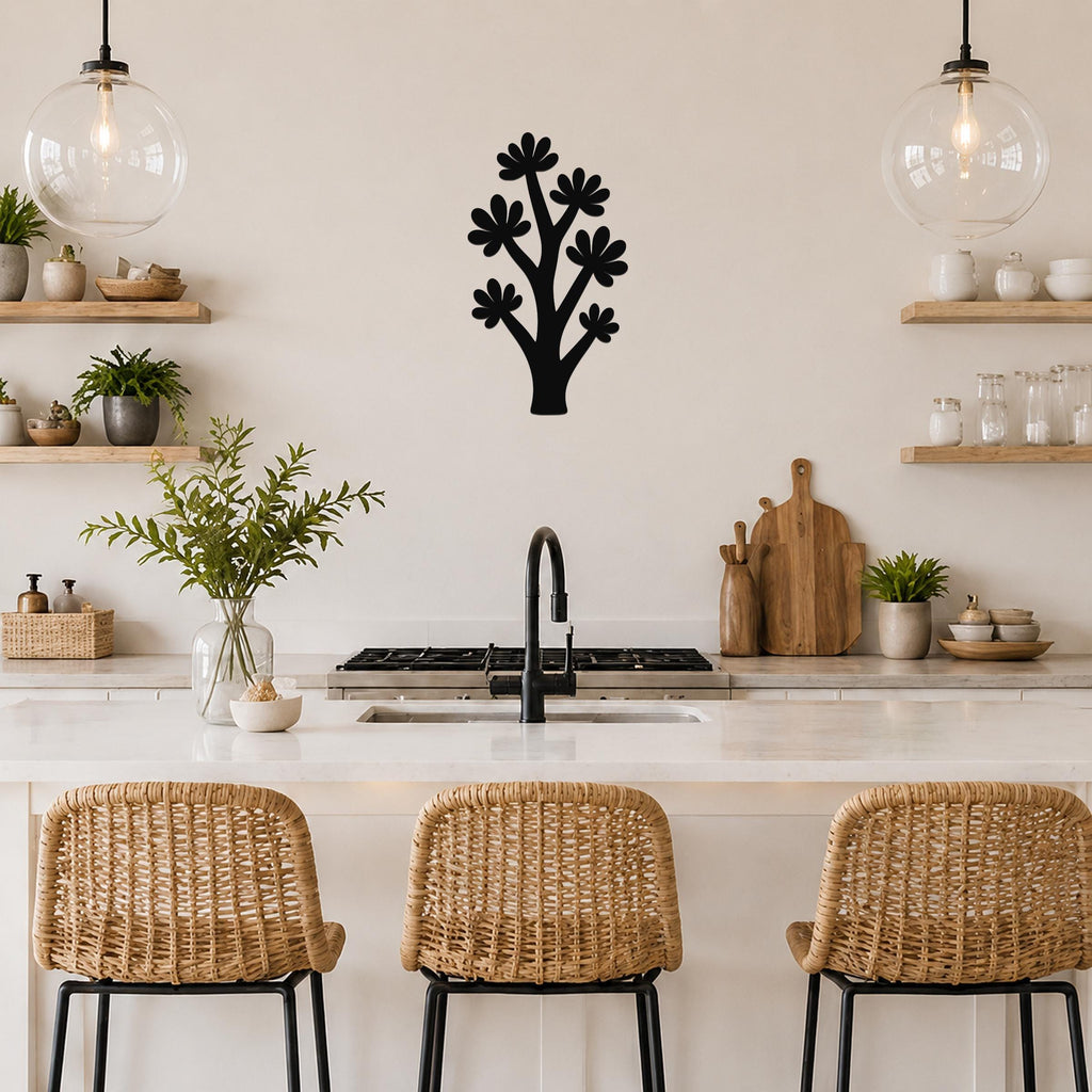 Black metal wall art in a stylized tree shape with flower cutouts, mounted on a kitchen wall above a counter.