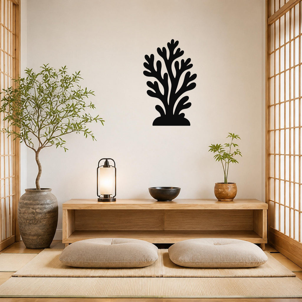 Black metal coral wall art with branching cutouts, mounted on a beige wall above a wooden console in a minimalist living room.