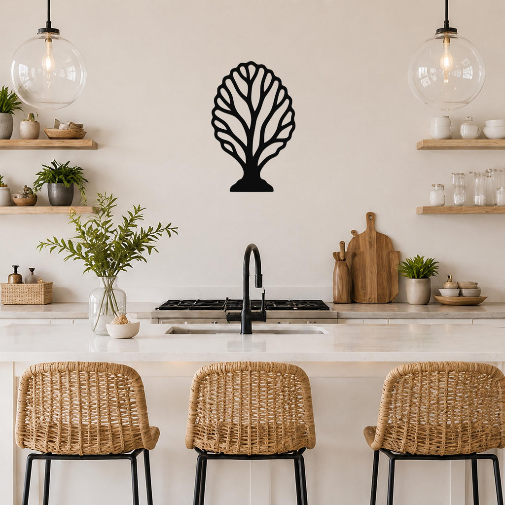 Black metal fan coral wall art with intricate cutout branches, mounted on a kitchen wall above a counter.