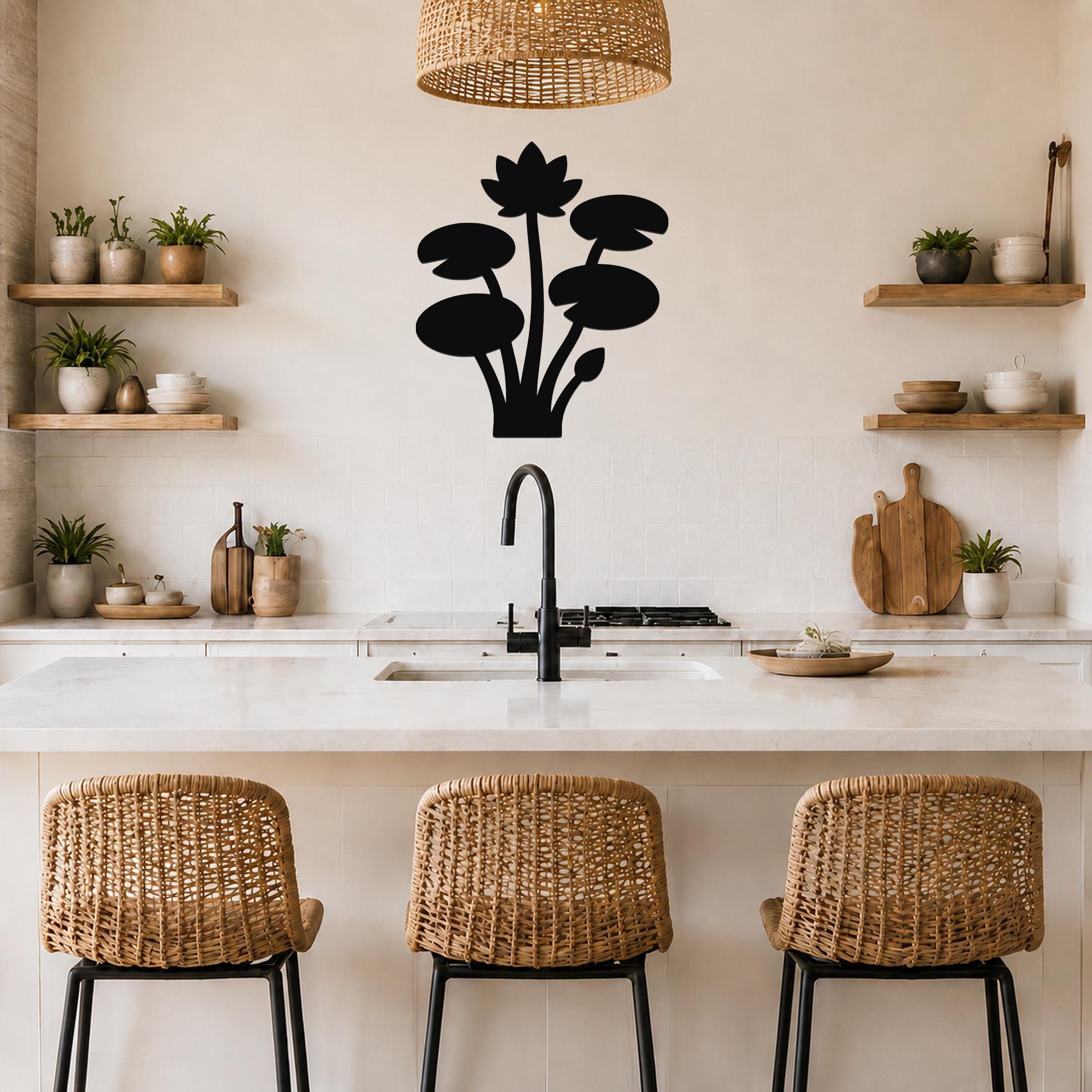 Black metal lotus water lily wall art with silhouette cutouts of flowers and leaves, mounted on a kitchen wall above a counter.