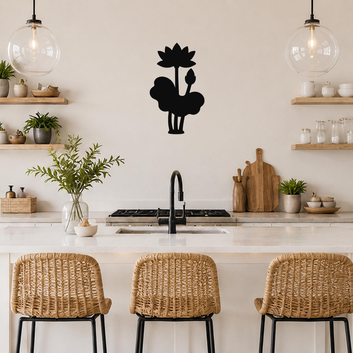 Black metal lotus wall art silhouette with flower and leaf cutouts, mounted on a kitchen wall above a counter.