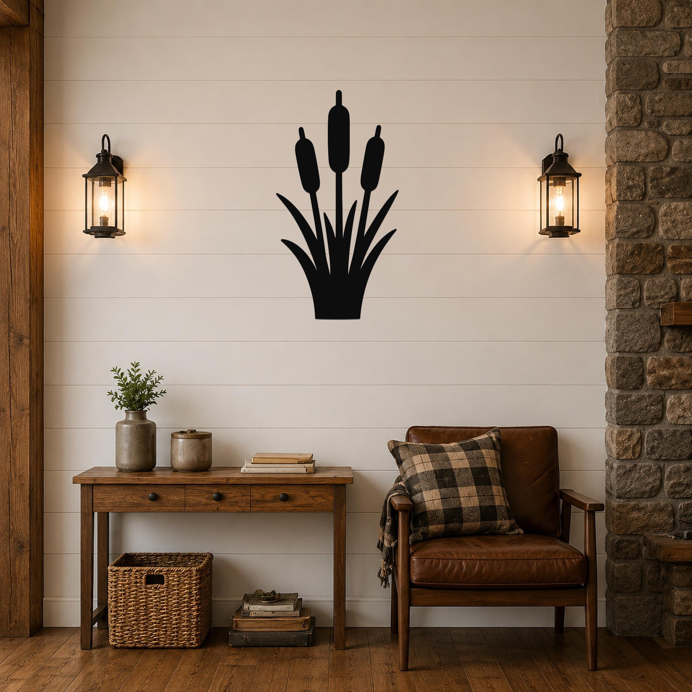 Black metal cattail wall art silhouette mounted on a white shiplap wall above a wooden console table in a living room.