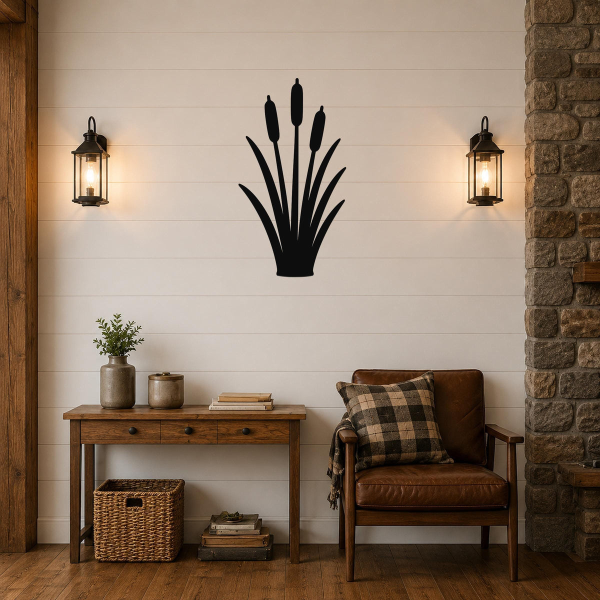 Black metal cattail wall art silhouette mounted on a shiplap wall above a wooden console table in a living room.