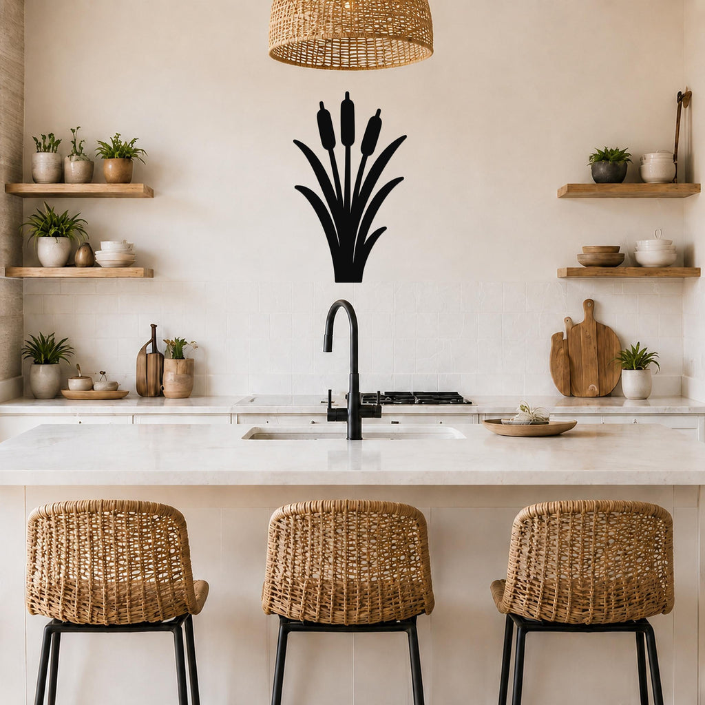 Black metal cattail wall art silhouette mounted on a kitchen wall above a counter, with a wicker pendant light and woven bar stools visible below.