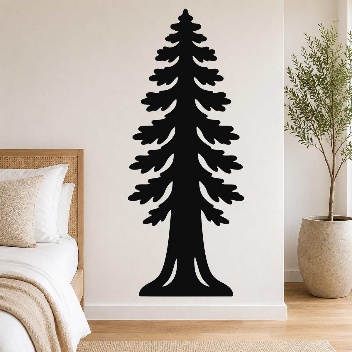 Black metal wall art of a sequoia tree silhouette with layered branches and a wide base, mounted on a bedroom wall above a bed.