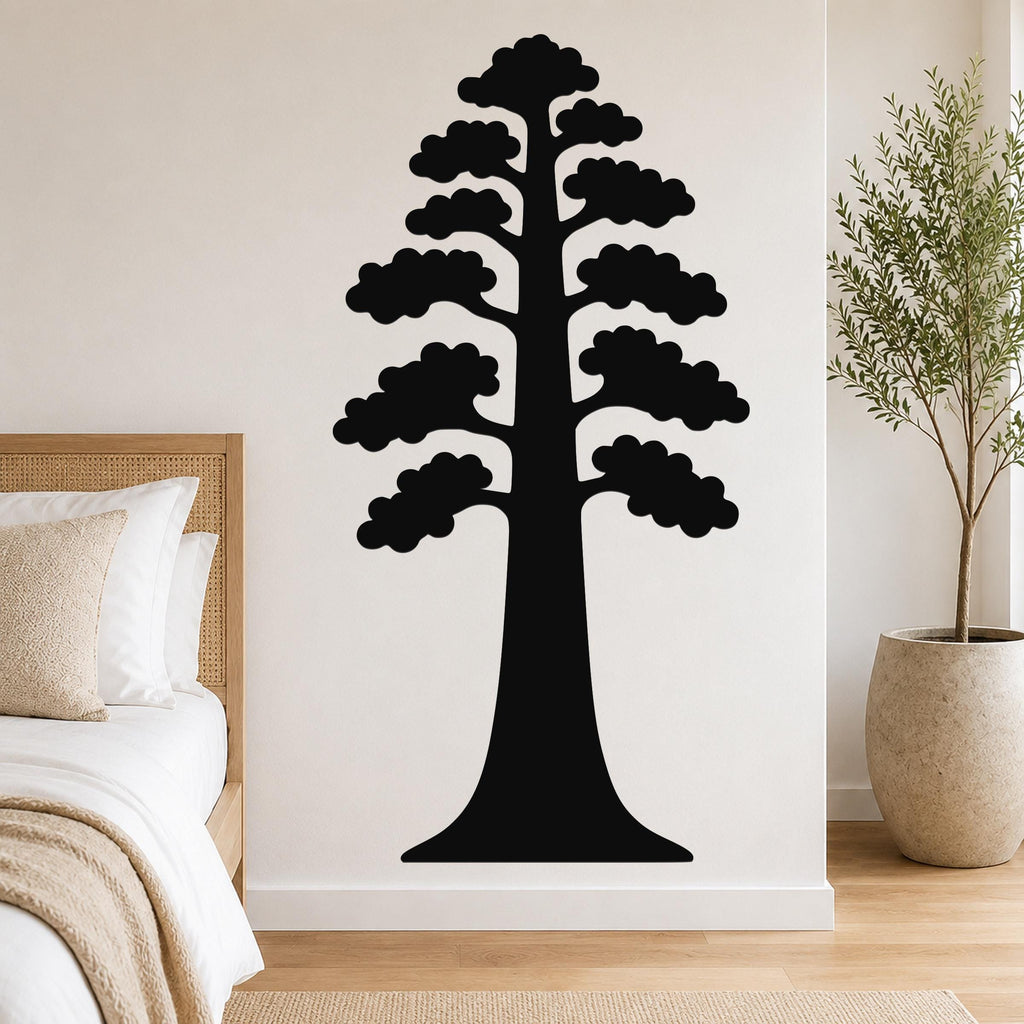 Black metal wall art of a sequoia tree silhouette with layered branches, mounted on a bedroom wall above a bed.