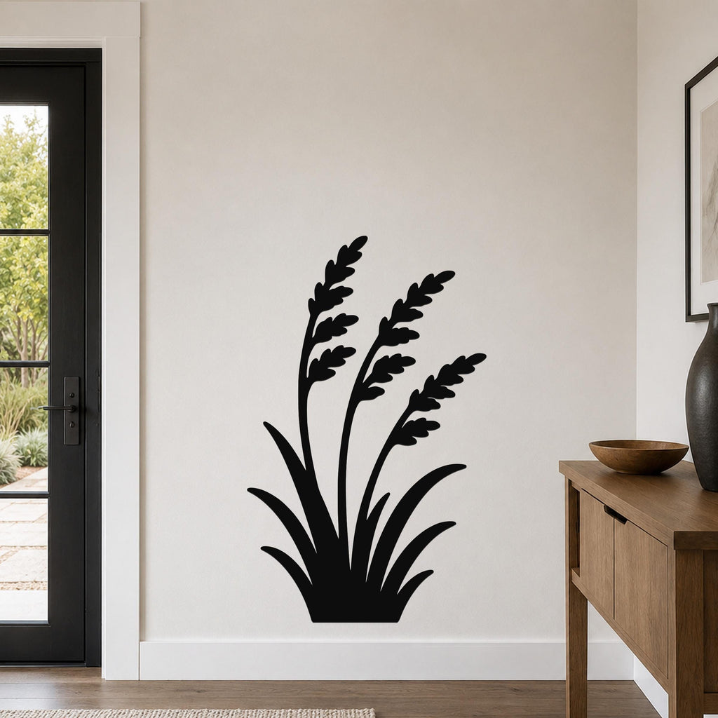 Black metal wall art in a wild grass silhouette design, mounted on a light-colored wall in a living room near a door and console table.