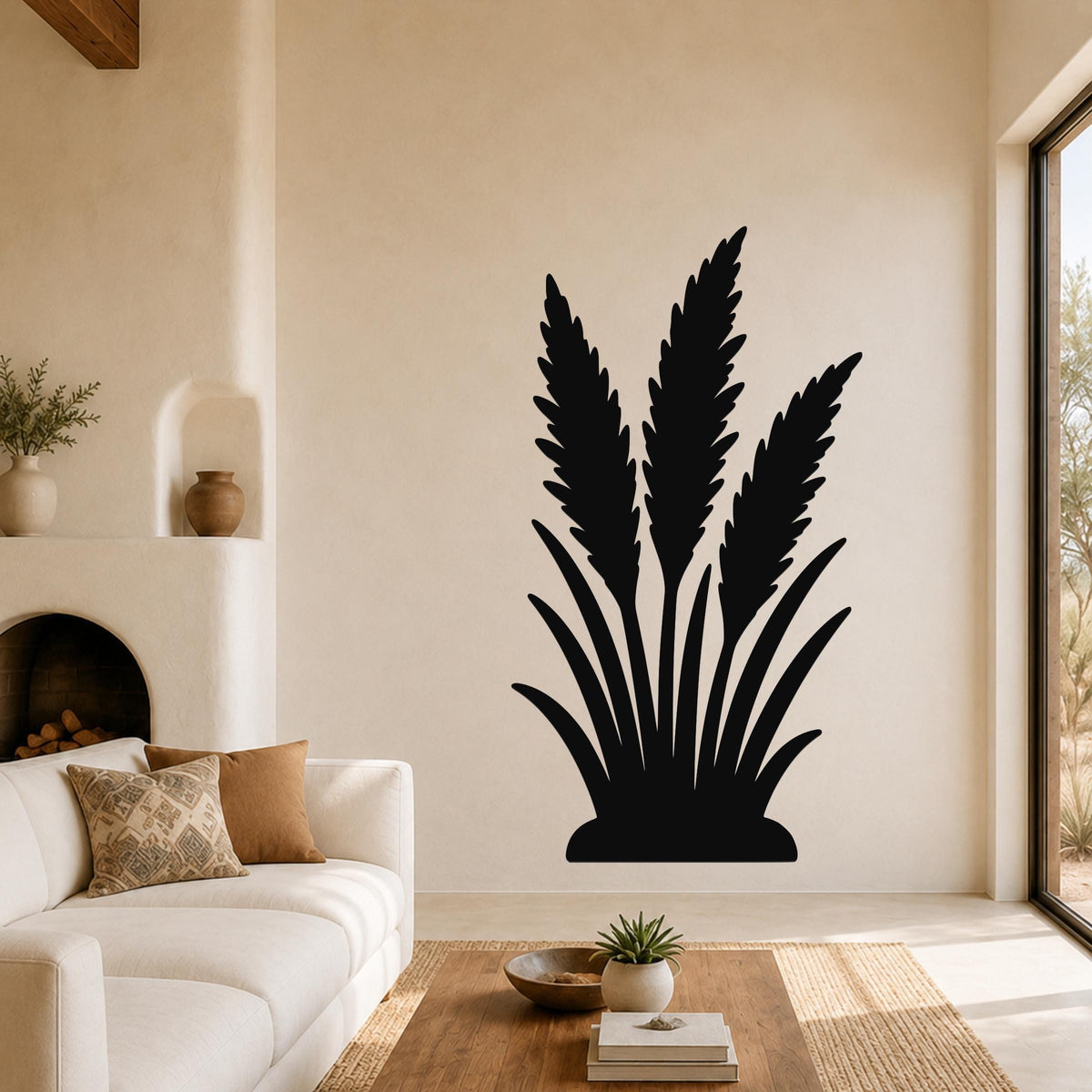 Black metal wall art in a wild grass silhouette, mounted on a living room wall above a sofa.