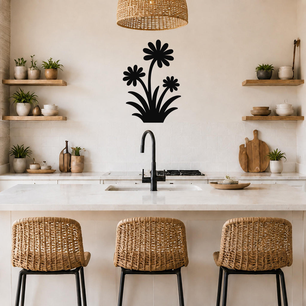Black metal wall art with a wildflower silhouette of three daisies and leaves, mounted on a kitchen wall above a counter.