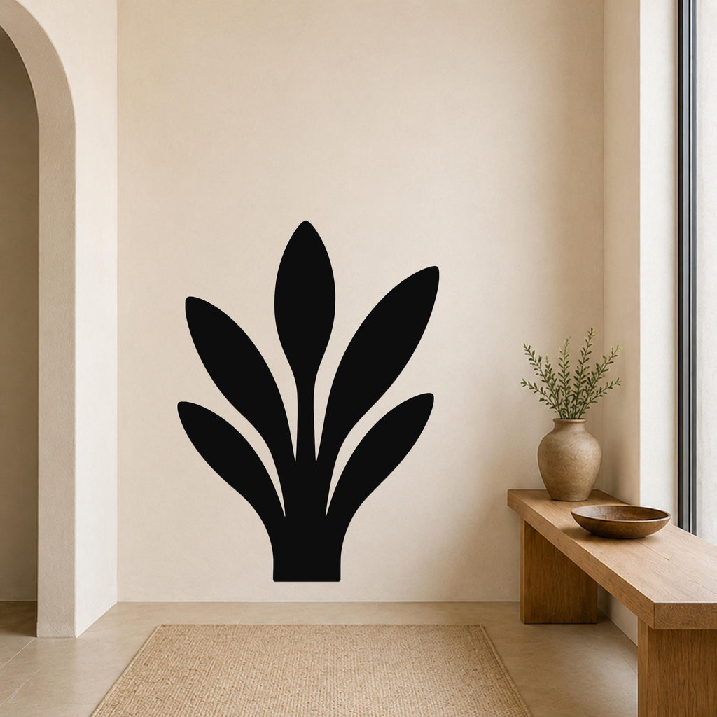 Black metal wall art in a silhouette of a snake plant, mounted on a beige wall above a wooden bench in a minimalist entryway.