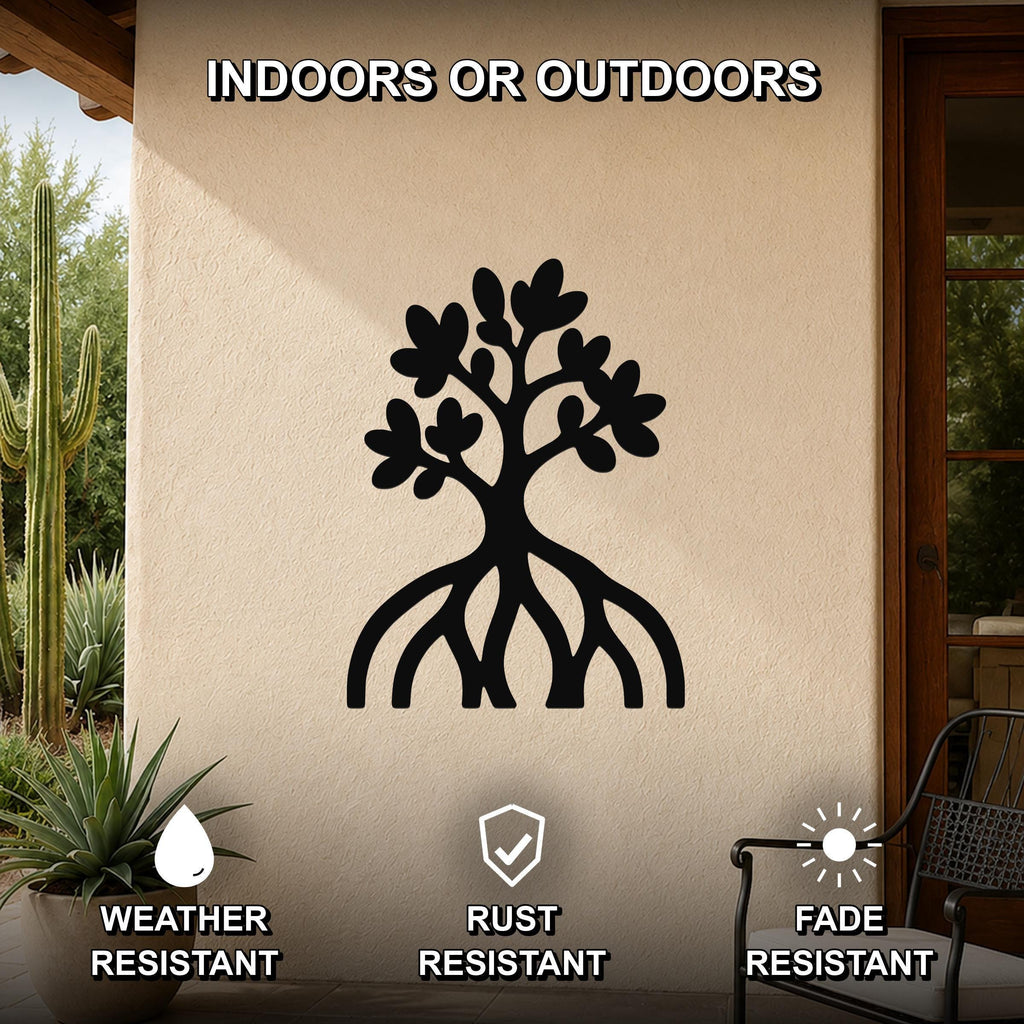 Black metal wall art in the shape of a tree with visible roots and leaf cutouts, mounted on an outdoor wall above a patio with plants and a chair.