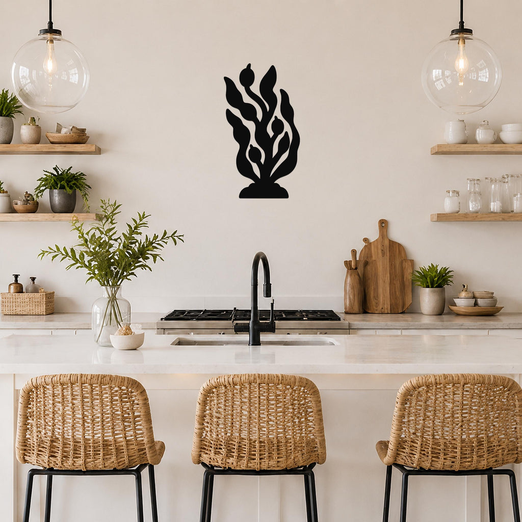 Black metal kelp and seaweed wall art with leafy cutouts, mounted on a kitchen wall above a counter.