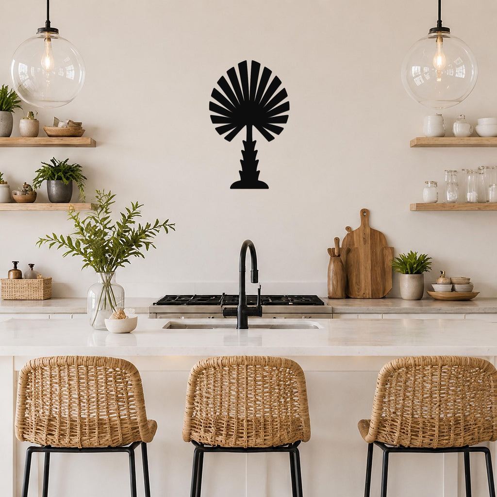 Black metal palm tree wall art with fan-shaped fronds, mounted on a kitchen wall above a counter with wicker bar stools.
