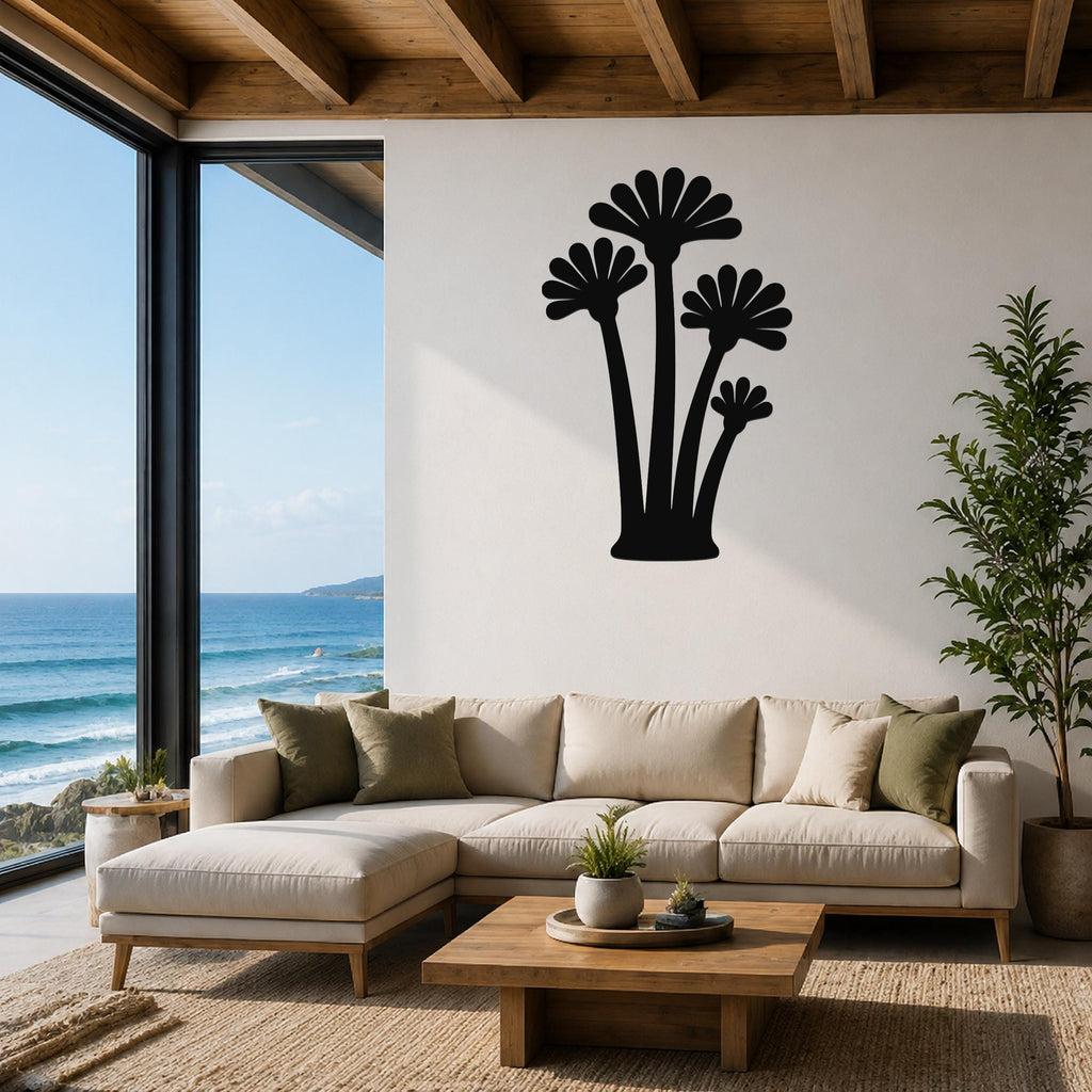 Black metal wall art featuring a fan palm tree silhouette, mounted on a living room wall above a beige sectional sofa.