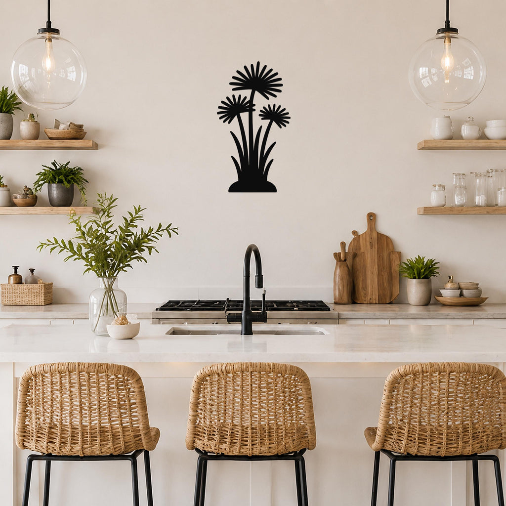 Black metal wall art featuring a silhouette of three daisy-like flowers with long stems, mounted on a kitchen wall above a counter.