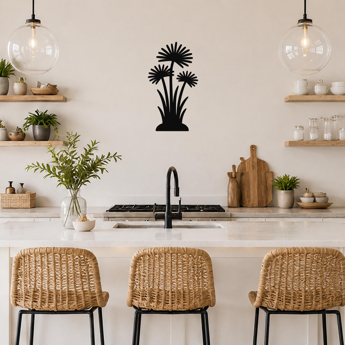 Black metal wall art featuring a silhouette of three daisy-like flowers with long stems, mounted on a kitchen wall above a counter.