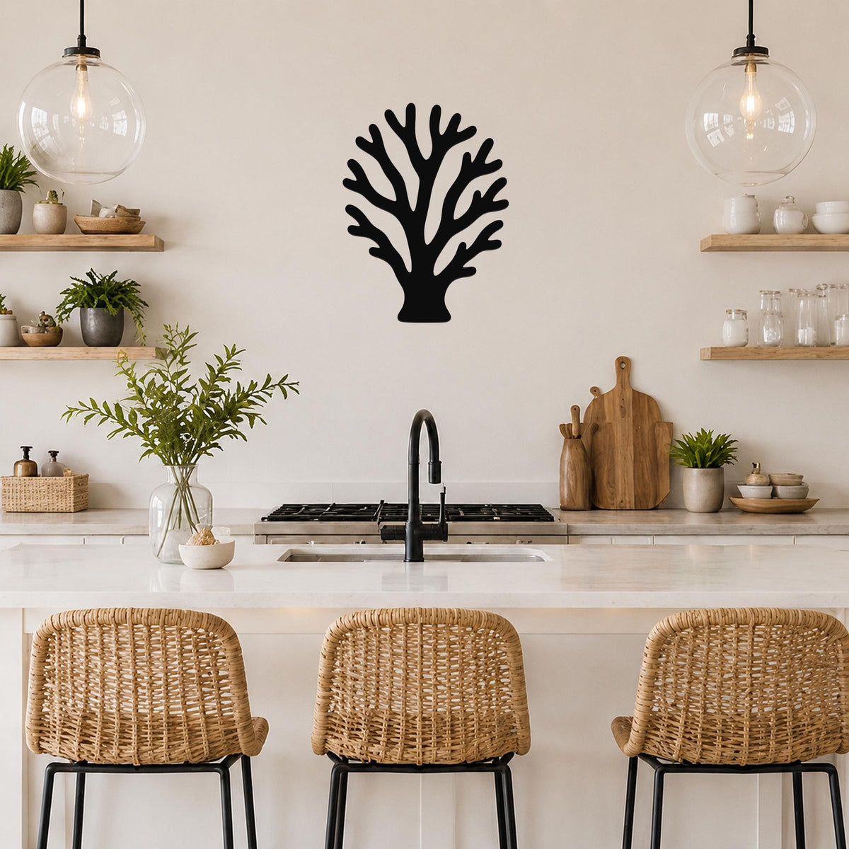 Black metal branching coral wall art with intricate cutout details, mounted on a kitchen wall above a counter.