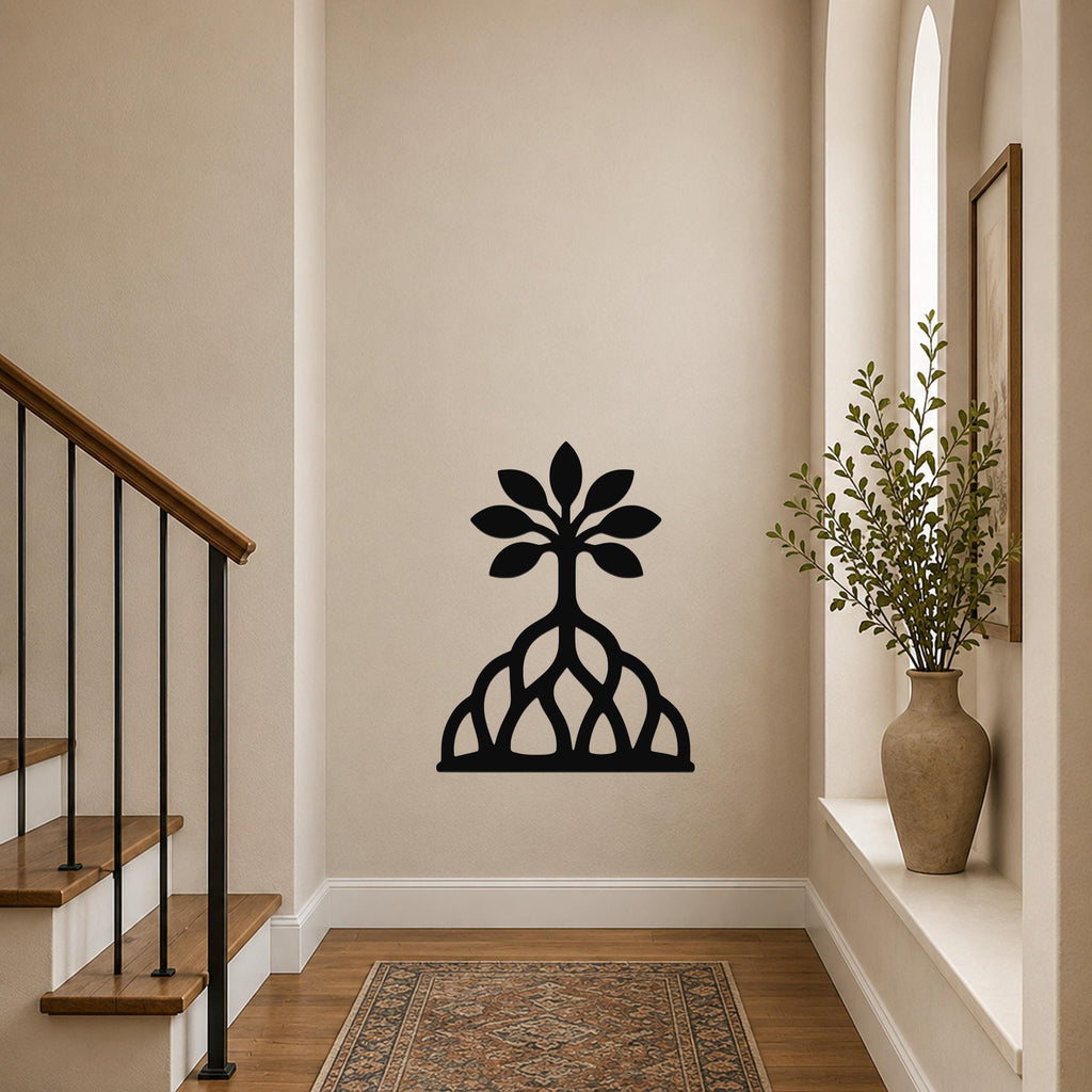 Black metal wall art cutout of a tree with roots and leaves, mounted on a hallway wall above a patterned rug near a staircase.