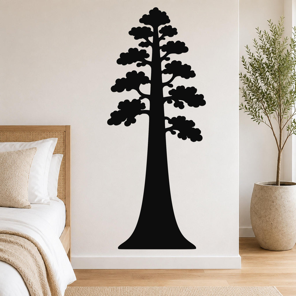 Black metal sequoia tree wall art with layered branch cutouts, mounted on a bedroom wall above a bed.